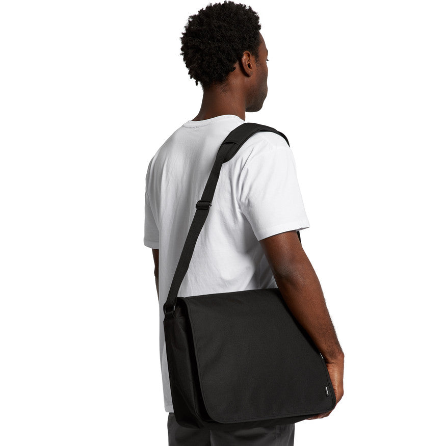 Man wearing a black crossbody bag on a white background