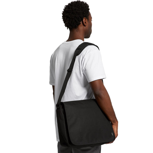 Man wearing a black crossbody bag on a white background