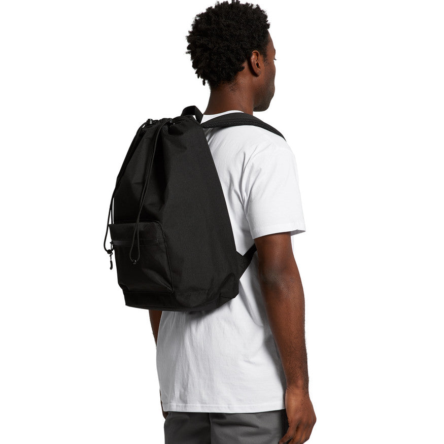 Person wearing a black backpack on a white background