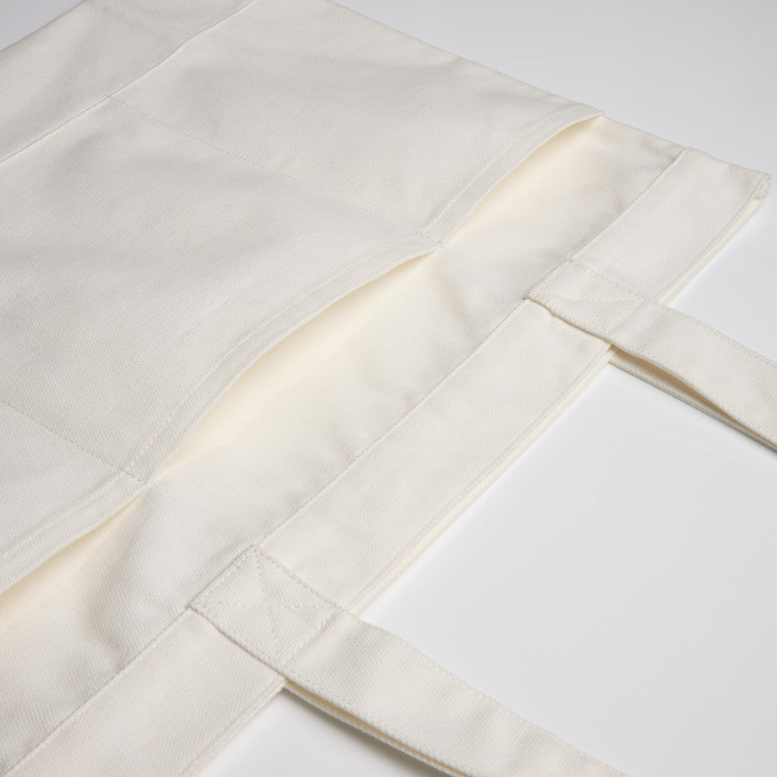 Close-up of premium white patterned fabric texture, a high-quality blank apparel option for custom embroidery or Supacolor transfers in Christchurch.