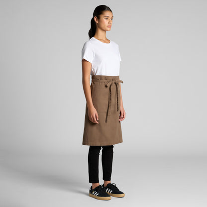 Full-body view of a female wearing a professional brown hospitality apron over a blank white shirt and black pants, an ideal uniform combination for Christchurch cafes and restaurants seeking custom branding.