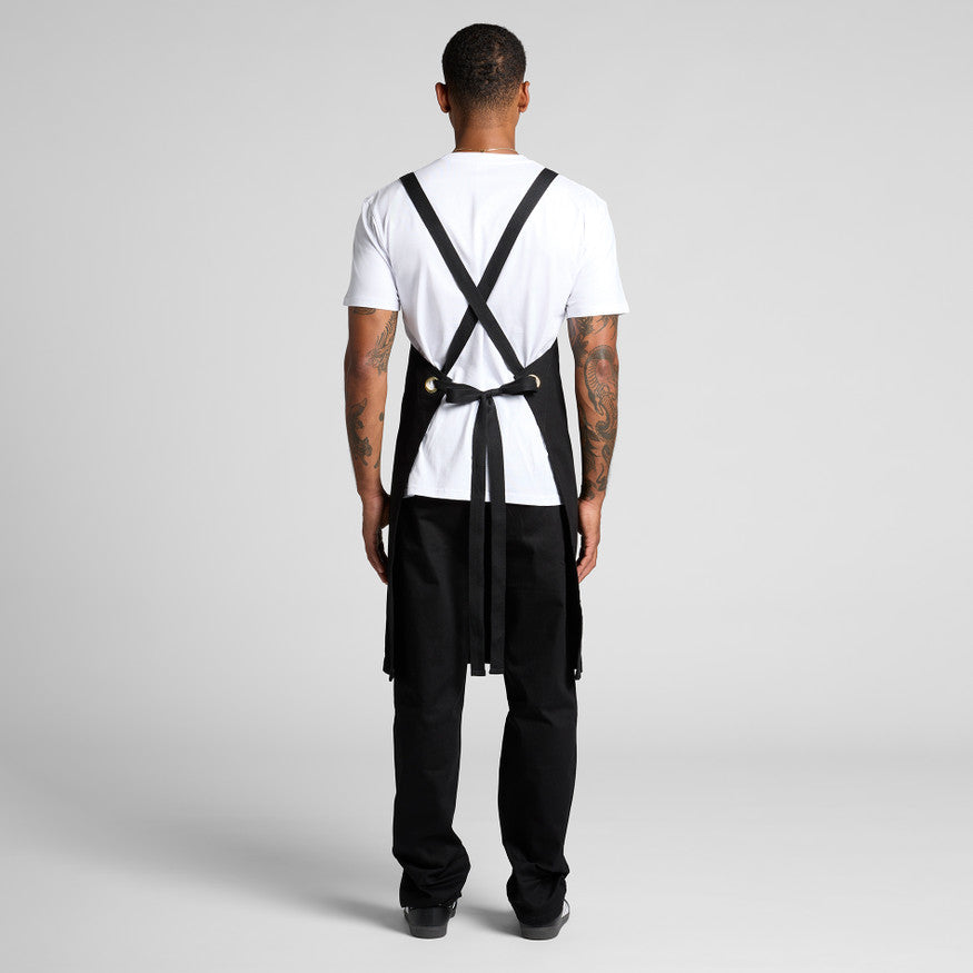 A person wearing a classic white blank t-shirt and durable black overalls, a practical workwear uniform combination suitable for custom Christchurch branding with embroidery or Supacolor transfers.