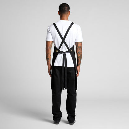 A person wearing a classic white blank t-shirt and durable black overalls, a practical workwear uniform combination suitable for custom Christchurch branding with embroidery or Supacolor transfers.