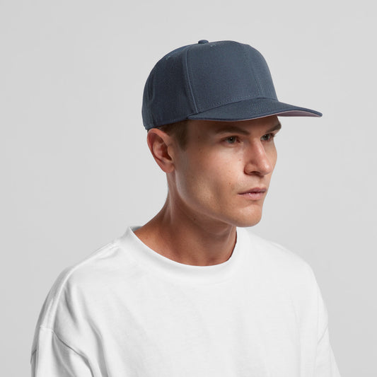 Man wearing a green cap on a gray background