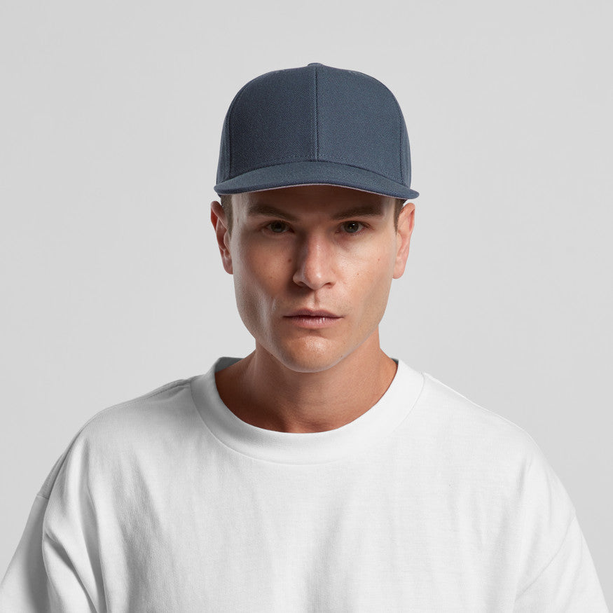 Man wearing a green cap on a gray background