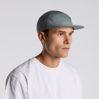 Man wearing a gray cap and white shirt against a light gray background