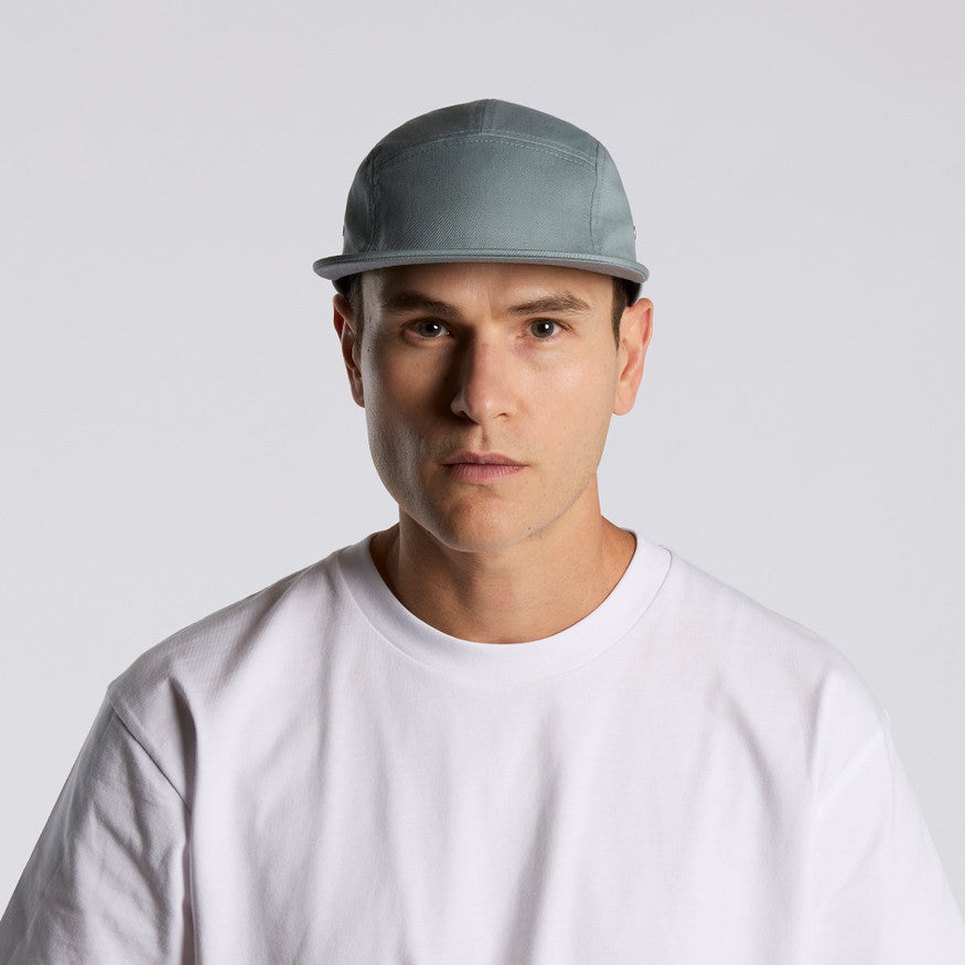 Man wearing a gray cap and white shirt against a light gray background