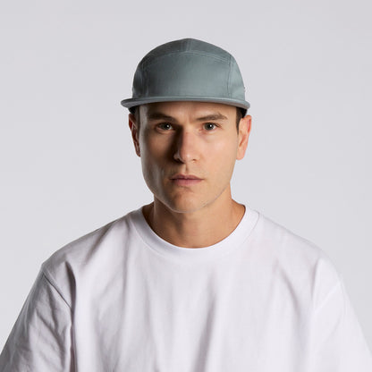 Man wearing a gray cap and white shirt against a light gray background