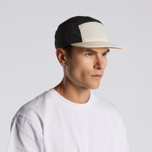 Man wearing a black and beige cap on a white background
