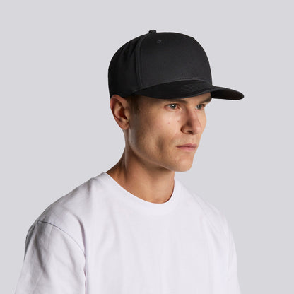 Man wearing a black cap and white t-shirt against a light gray background