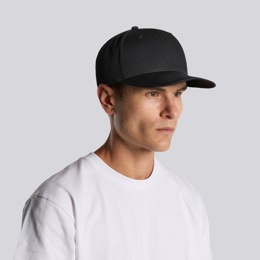 Man wearing a black cap and white t-shirt against a light gray background