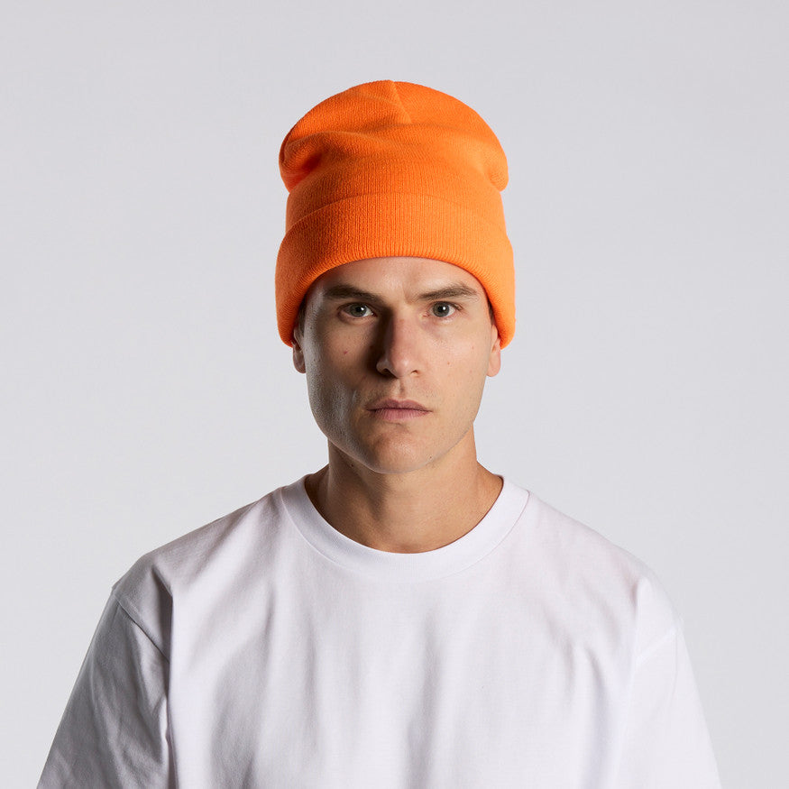 Person wearing an orange beanie and white shirt against a light gray background
