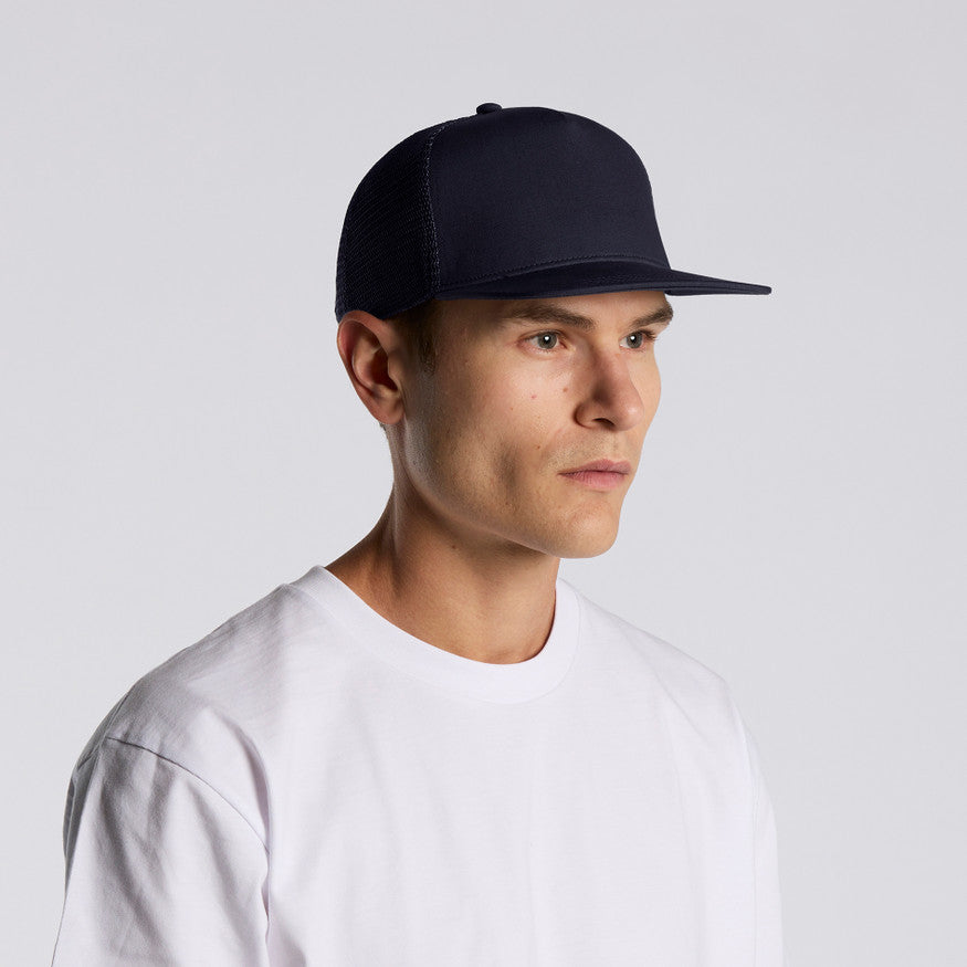 Man wearing a black cap and white shirt on a light gray background