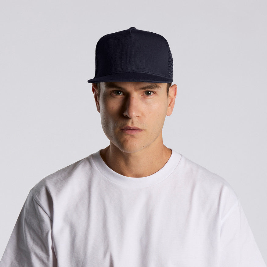 Man wearing a black cap and white t-shirt against a light gray background