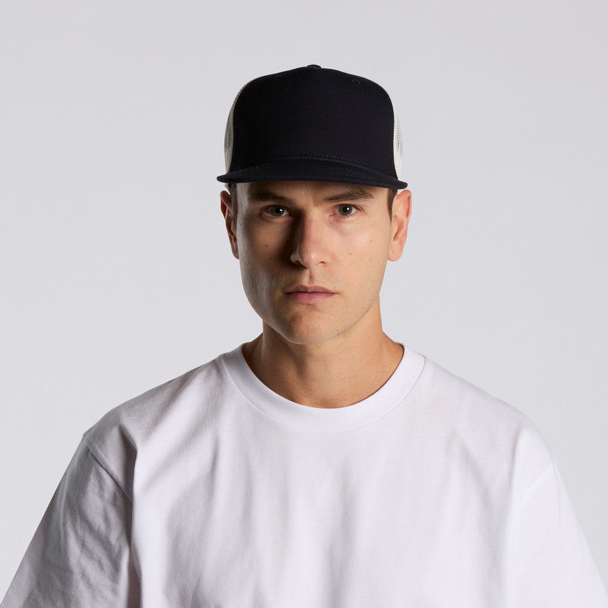 Man wearing a black cap and white t-shirt against a light gray background