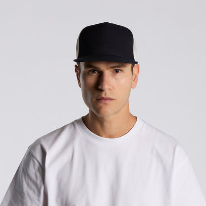 Man wearing a black cap and white t-shirt against a light gray background