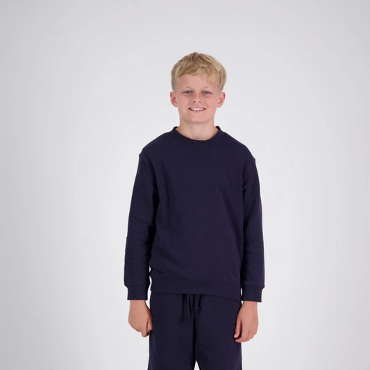 Young boy wearing a navy blue sweatshirt and pants on a white background