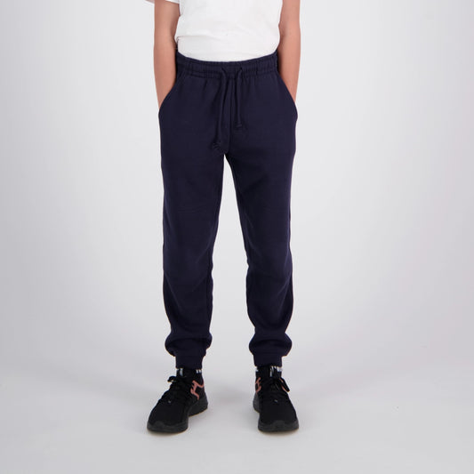 person wearing blue sweat pants white ground