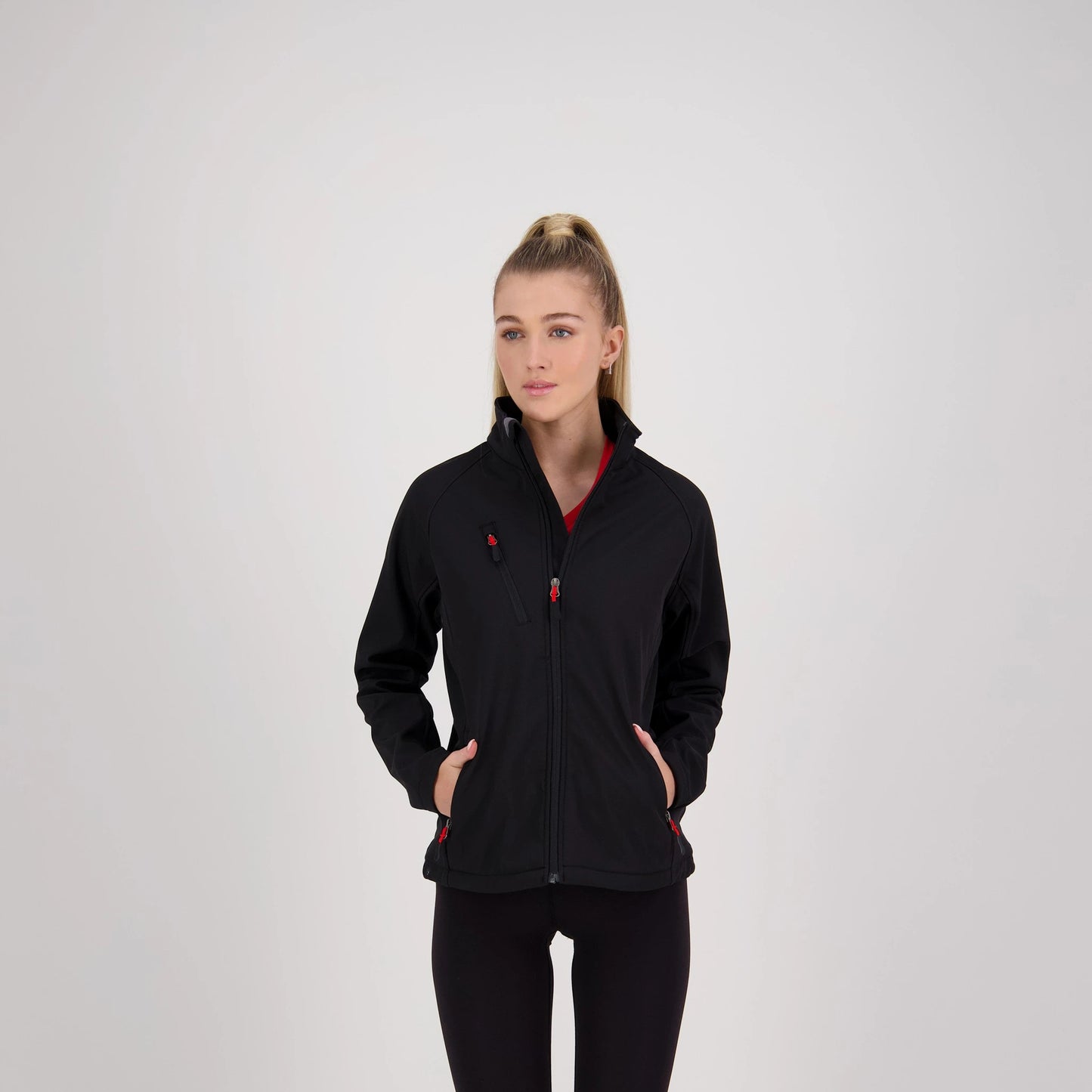 Woman wearing a black jacket with red accents on a white background