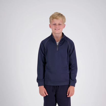 Young boy wearing a navy blue pullover and pants on a white background
