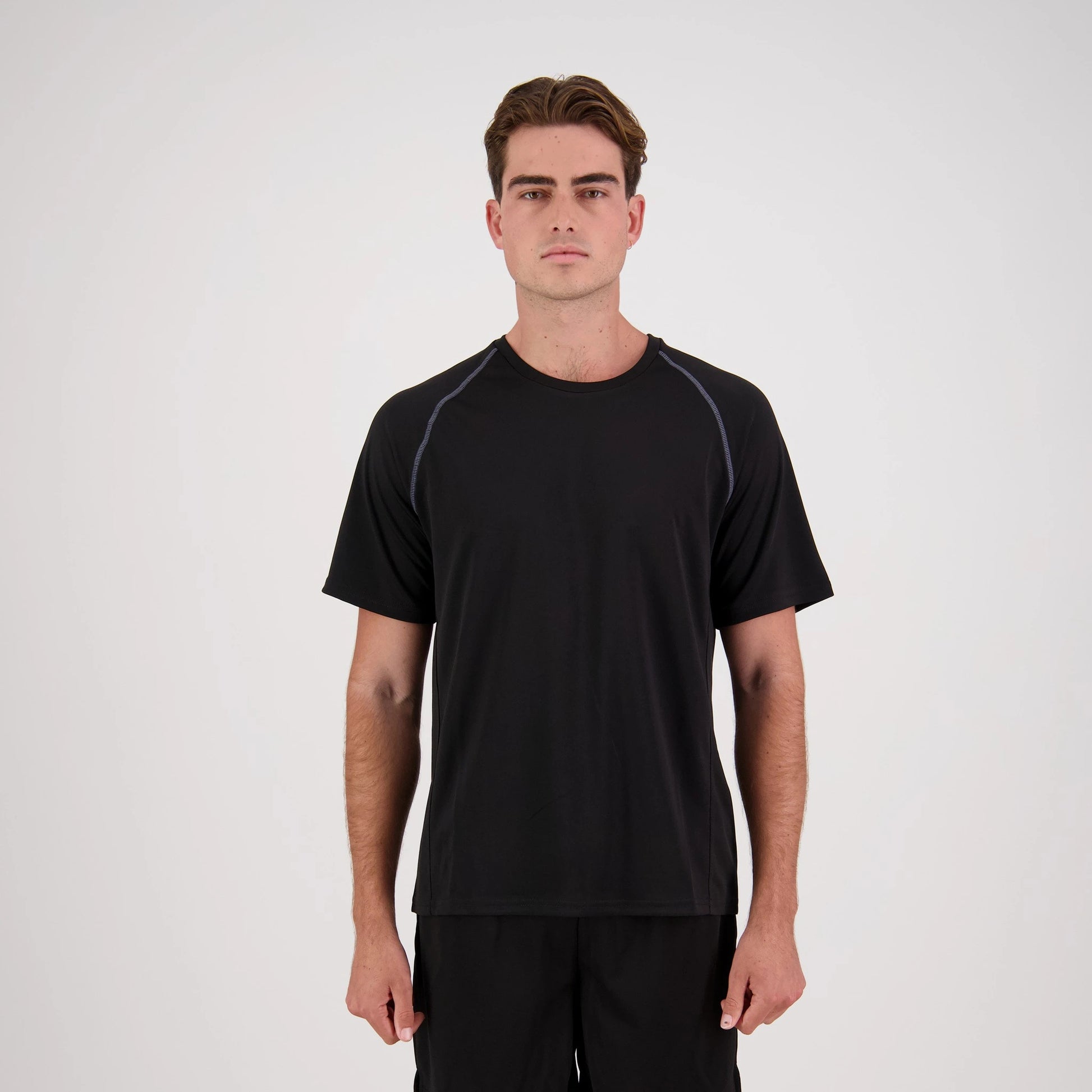 Man wearing a black athletic outfit on a white background